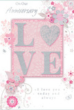 Shown against a neutral backdrop, this anniversary card glows with understated romance and refined detail, much like the thoughtful arrangements prepared by Flower Delivery North Kensington for local couples. At its core, the word LOVE spans the centre in bold, raised letters, each softened by a veil of frosted glitter. The glitter is finely milled and primarily silver, catching hints of light that create a delicate shimmer without overwhelming the senses. The letters rest against a smooth blush-pink background, calm and even in tone, evoking the warmth of evening light over the townhouses near Ladbroke Grove. Encircling this main word, an airy design of illustrated blooms and scrolling foliage drifts across the card. The flowers are gracefully stylised, with slender outlines and subtle shading in powder pinks, pearly whites, and cool greys, recalling the gentle palette of romantic bouquets often chosen for anniversaries. Curving stems and vines frame the word, their arcs and loops echoing the fluid lines of a florist tying stems into place. Small flourishes-tiny leaves, petal-like shapes, and decorative curls-add movement and fill negative space without clutter. Select elements carry a touch of silver accent, mirroring the shimmer of the central letters. Towards the lower section, an anniversary message is penned in an elegant script, its flowing characters visually entwined with the floral motifs. Together, these details create the impression of a hand-tied bouquet captured in ink and glitter, a paper keepsake that quietly honours enduring love in North Kensington's blend of classic charm and modern life.
